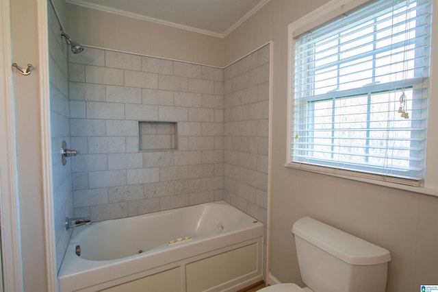 bathroom featuring toilet, tiled shower / bath combo, and ornamental molding