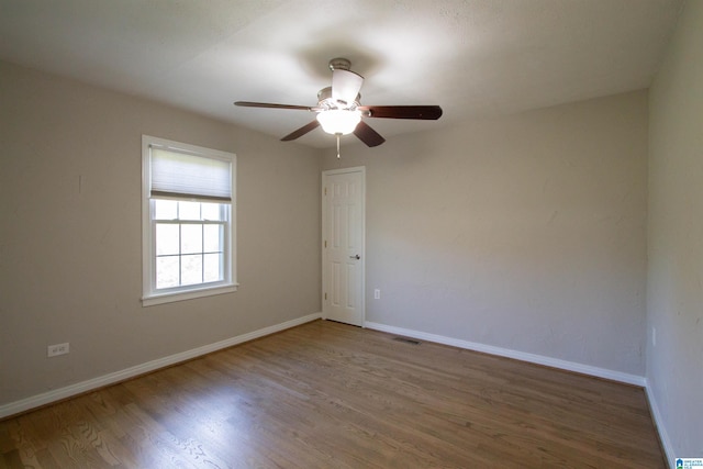 spare room featuring hardwood / wood-style floors and ceiling fan