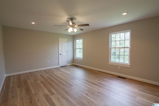 empty room featuring light wood-type flooring and ceiling fan