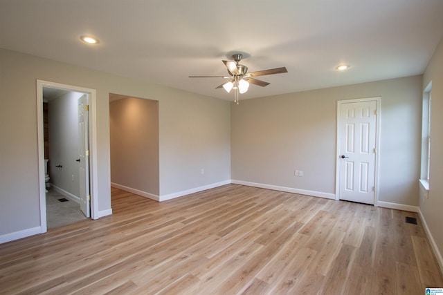 spare room featuring light hardwood / wood-style floors and ceiling fan