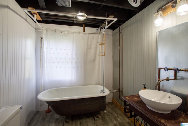 bathroom with hardwood / wood-style flooring, sink, and separate shower and tub