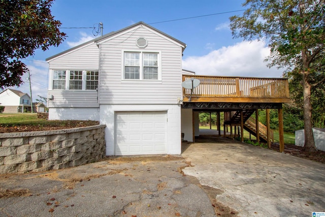 view of home's exterior with a garage and a wooden deck