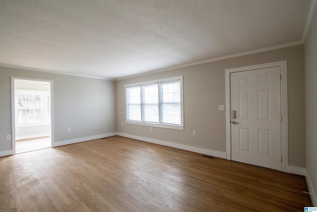 entryway featuring ornamental molding and hardwood / wood-style floors