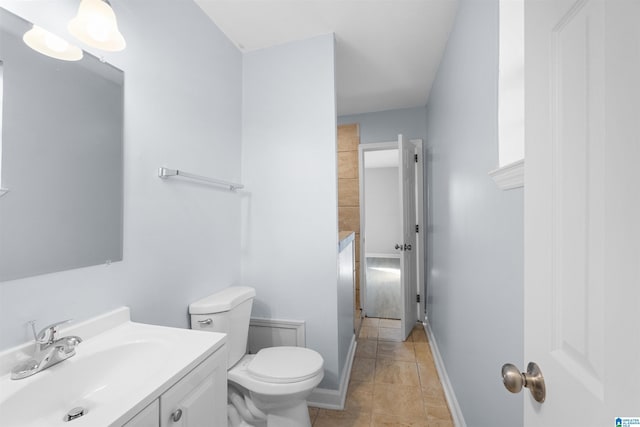 bathroom featuring tile patterned floors, vanity, and toilet