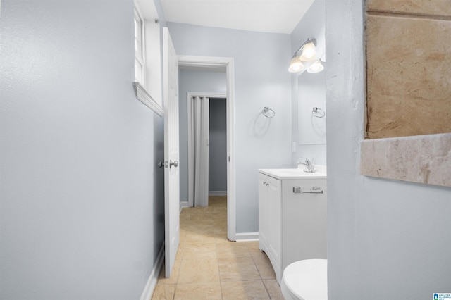 bathroom with tile patterned flooring, vanity, and toilet