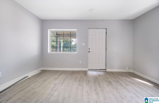 spare room with light wood-type flooring