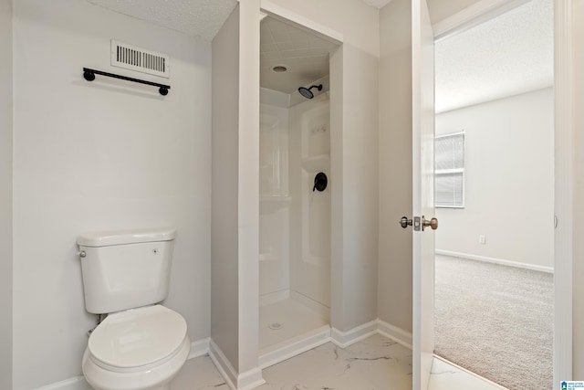 bathroom featuring toilet and a shower