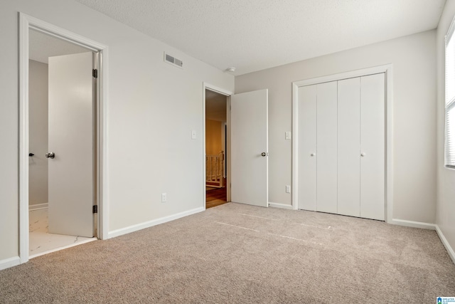 unfurnished bedroom featuring light colored carpet and multiple windows