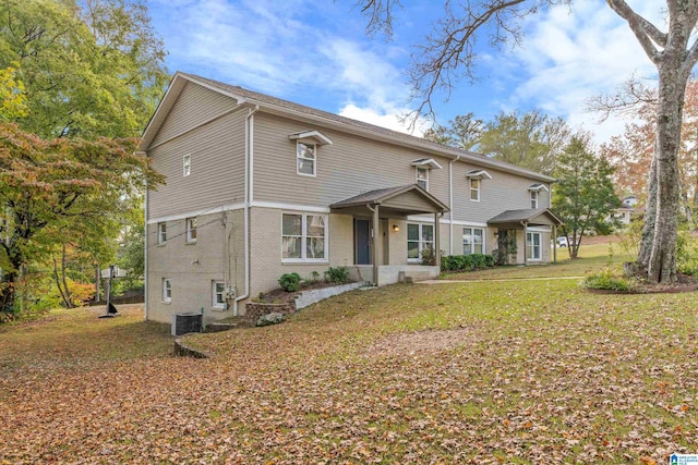 front of property featuring central AC unit and a front yard