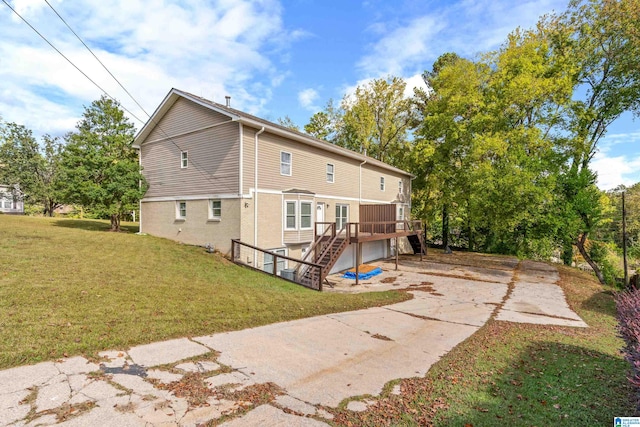 back of house featuring a lawn and a wooden deck