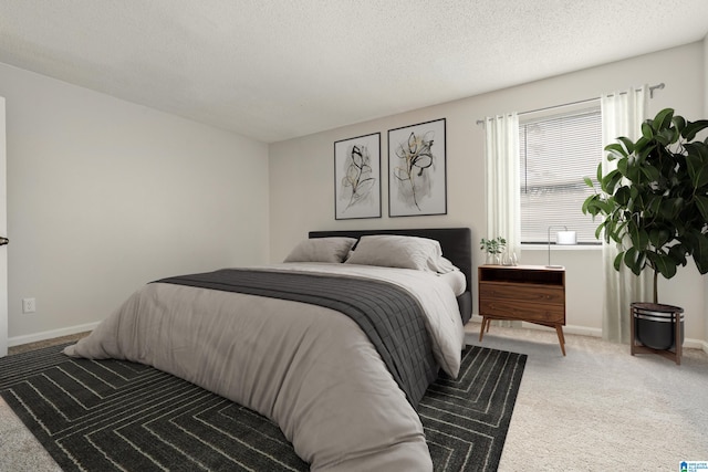 bedroom featuring carpet and a textured ceiling