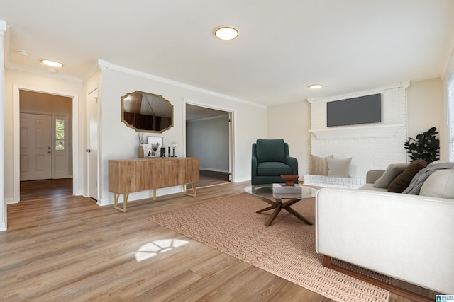 living room with ornamental molding and hardwood / wood-style floors