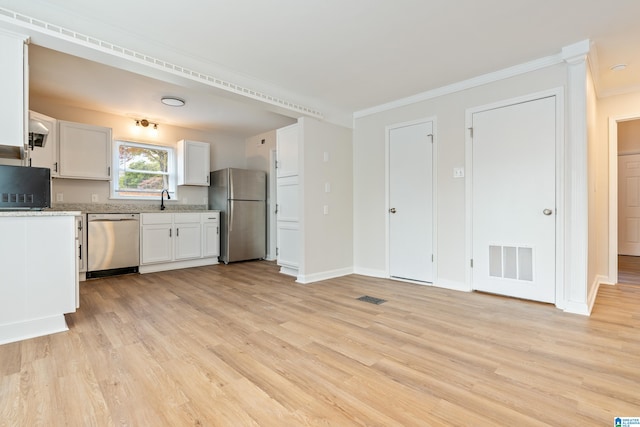 kitchen featuring white cabinetry, appliances with stainless steel finishes, light hardwood / wood-style floors, and crown molding