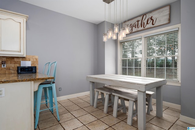 dining room featuring light tile patterned floors and an inviting chandelier