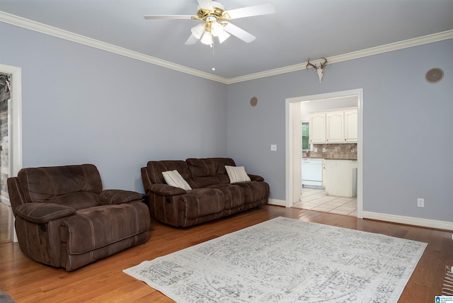 living room featuring light wood-type flooring, ceiling fan, and crown molding