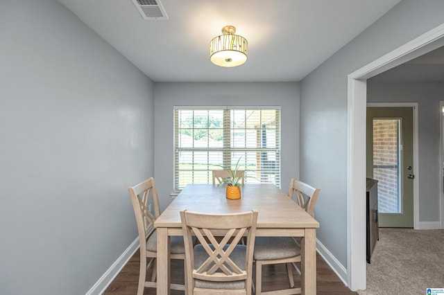 dining space featuring dark wood-type flooring