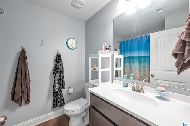 bathroom featuring vanity, hardwood / wood-style flooring, and toilet