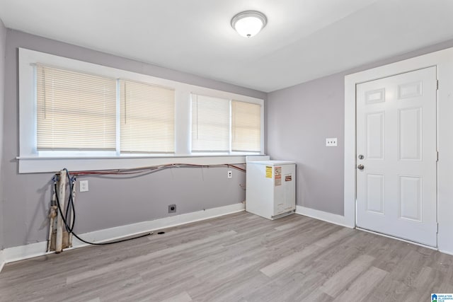 laundry area with light hardwood / wood-style flooring and electric dryer hookup