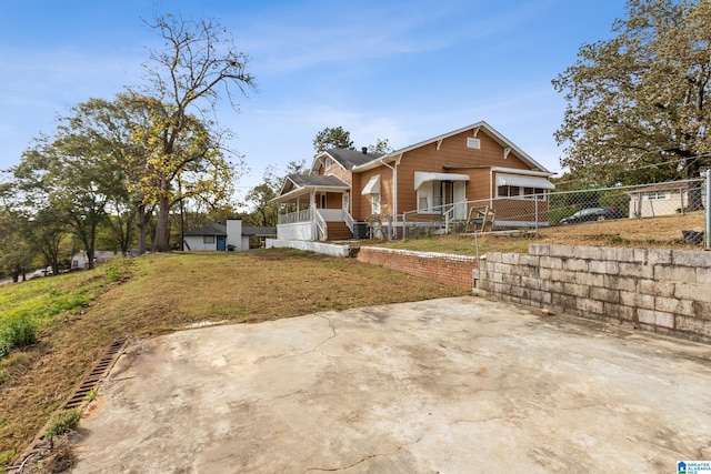 view of front of property featuring a garage, a front yard, and a sunroom