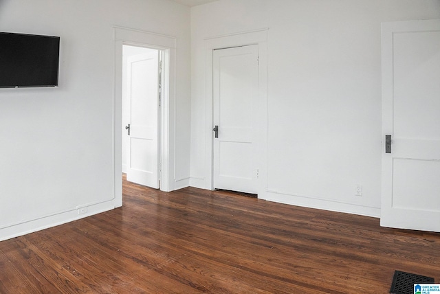 spare room featuring dark hardwood / wood-style floors