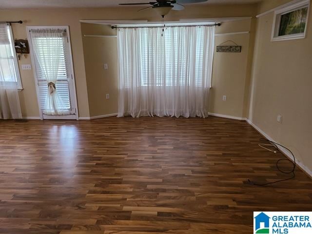 spare room with dark hardwood / wood-style floors and ceiling fan