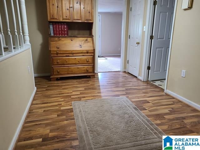 hall with dark hardwood / wood-style floors