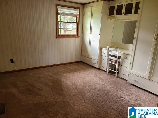 unfurnished bedroom featuring light carpet