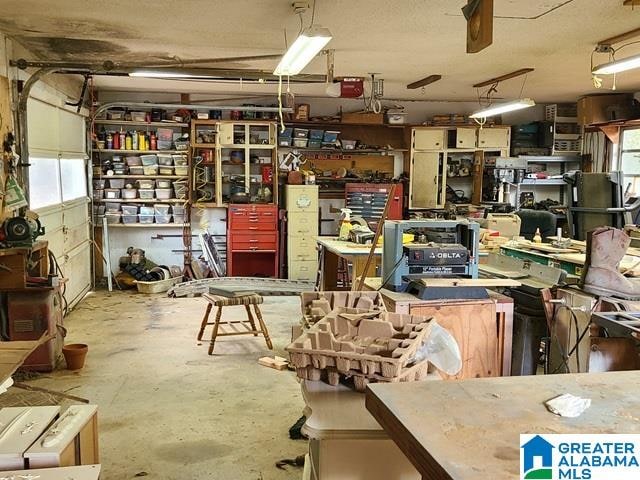 interior space with a workshop area, plenty of natural light, and concrete floors