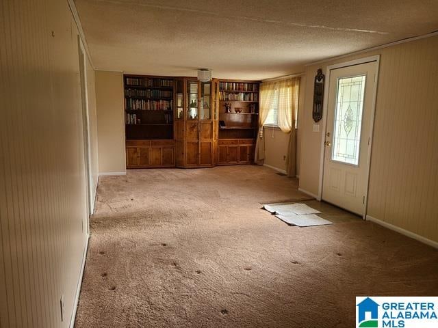 entryway with a textured ceiling and light colored carpet