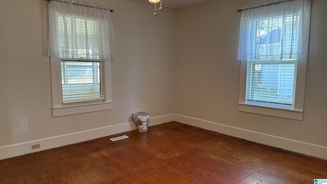 spare room with hardwood / wood-style floors, ceiling fan, and plenty of natural light