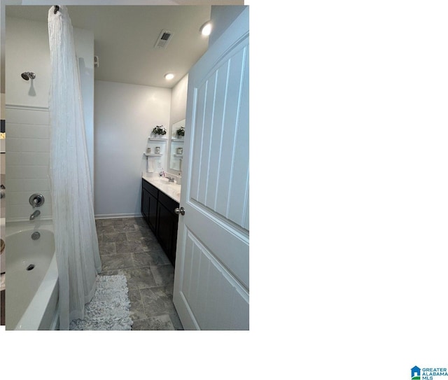 bathroom featuring tub / shower combination and vanity