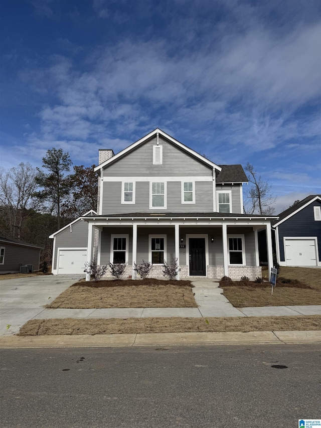 view of front of property with an outdoor structure, a porch, and a garage