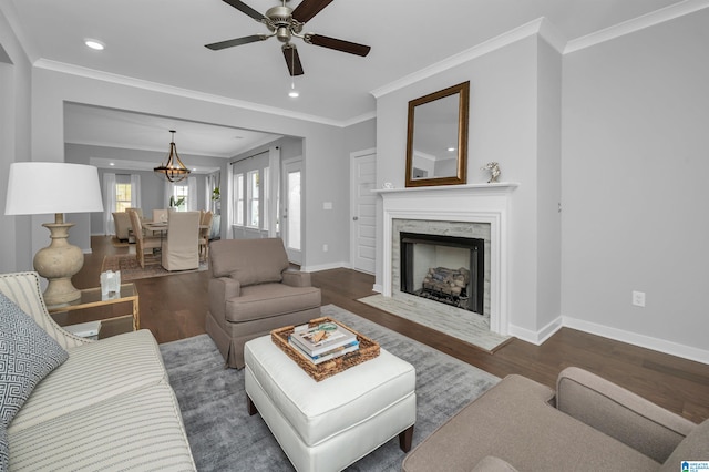 living room with a fireplace, crown molding, and dark hardwood / wood-style flooring