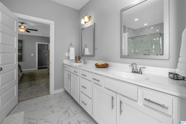 bathroom with ceiling fan, a shower with shower door, and vanity