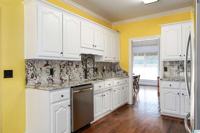 kitchen featuring white cabinets, appliances with stainless steel finishes, and light stone counters