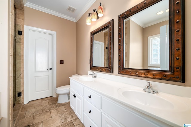 bathroom featuring toilet, vanity, a shower with door, and crown molding