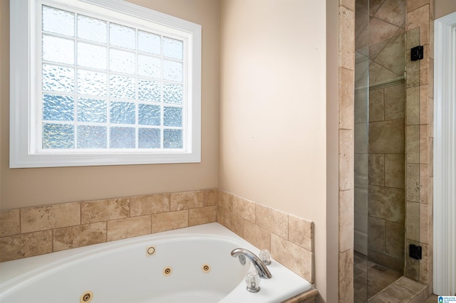 bathroom with a healthy amount of sunlight and shower with separate bathtub