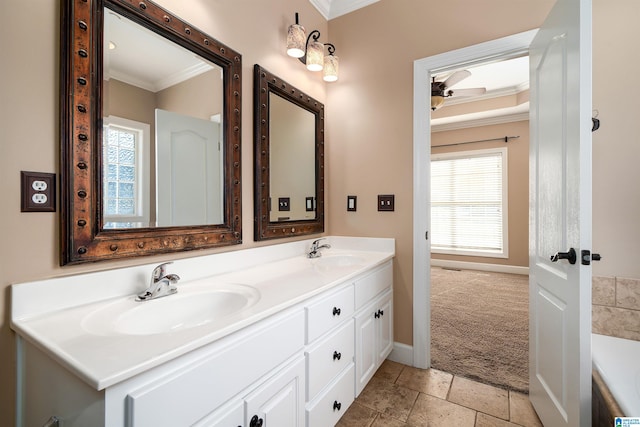 bathroom with a bathtub, vanity, and ornamental molding