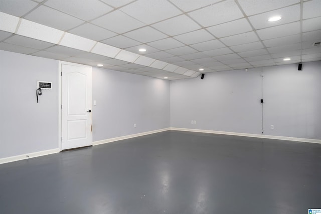 basement with a paneled ceiling