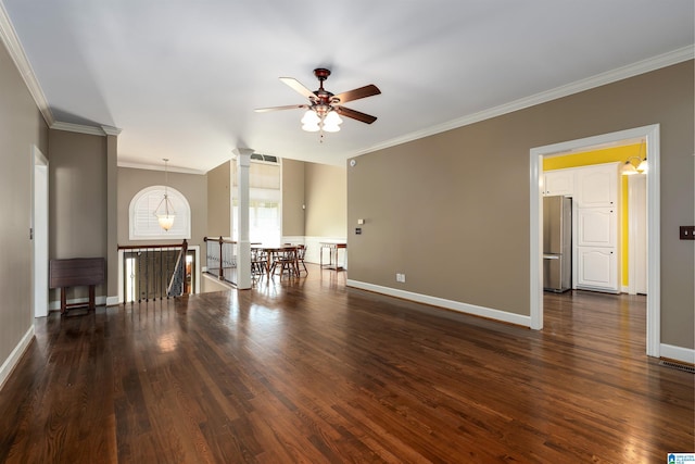 unfurnished room featuring dark wood-type flooring, decorative columns, ceiling fan, and ornamental molding