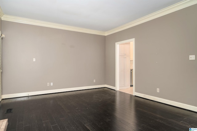 empty room featuring ornamental molding and hardwood / wood-style floors