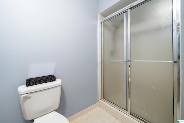 bathroom with toilet and an enclosed shower