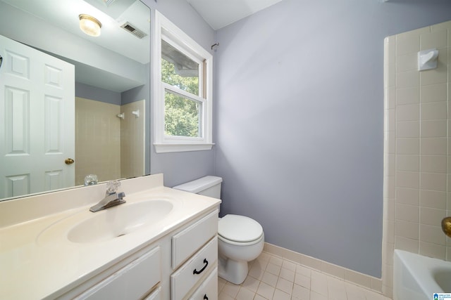 full bathroom featuring toilet, tiled shower / bath combo, vanity, and tile patterned floors