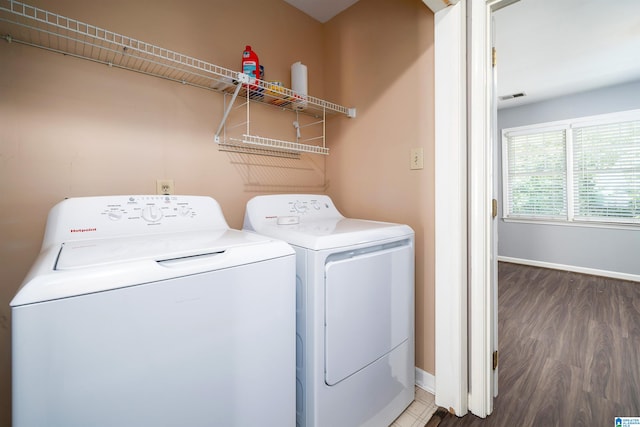 laundry room featuring dark wood-type flooring and washer and clothes dryer