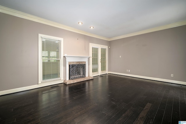 unfurnished living room featuring a fireplace, wood-type flooring, and crown molding