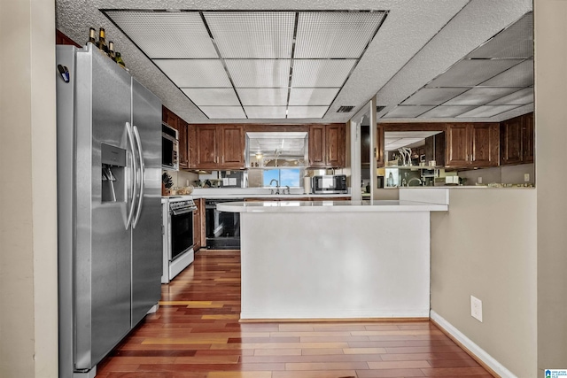 kitchen featuring dark hardwood / wood-style flooring, sink, and appliances with stainless steel finishes