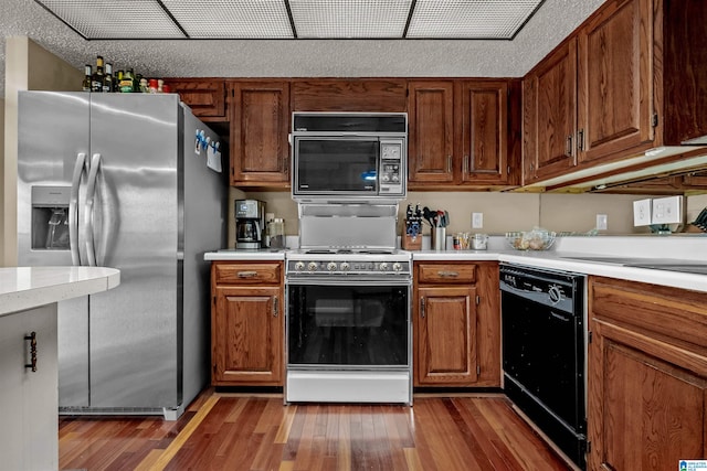 kitchen featuring black appliances and hardwood / wood-style flooring