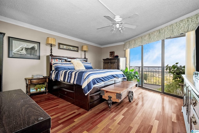 bedroom featuring hardwood / wood-style floors, ceiling fan, a textured ceiling, and crown molding