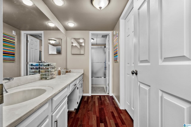 bathroom featuring shower / bath combination with glass door, wood-type flooring, and vanity