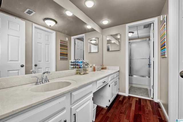 bathroom featuring combined bath / shower with glass door, vanity, and hardwood / wood-style flooring